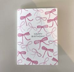 a birthday card with pink bows on it