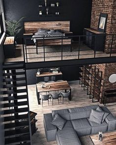 an aerial view of a living room and dining area in a loft style apartment with exposed brick walls