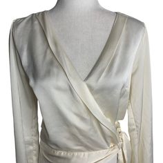 Abercrombie Fitch Silky Wrap Blouse S Cream Elastic Waist Long Sleeve Tie V NeckGood conditionSmall mark on the shoulder and one on the backChest: 18" laying flatSleeves: 23"Length: 19" shoulder to hem100% PolyesterMade in China Chic Silk Wrap Blouse, Spring Season Formal Wrap Blouse, Spring Evening Wrap Top With Long Sleeves, Spring Formal Wrap Blouse, Fitted Silk Wrap Blouse, Formal Wrap Blouse, Spring Formal Fitted Wrap Top, Spring Evening Wrap Blouse, Silk Wrap Top For Party