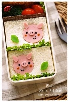 two little pigs made out of rice in a lunch box