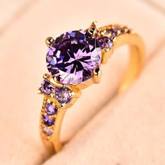 Material: Cubic Zirconia Surface Width: 6mm Setting Type: Prong Setting Occasion: Engagement, Wedding, Anniversary, Birthday, Special Occasion Amethyst Birthstone Ring, Amethyst Birthstone, Ring Settings Types, Purple Band, Purple Crystal, Solid Gold Jewelry, Purple Crystals, Engagement Jewelry, Crystal Stone