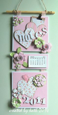 two pink and white wall hangings with flowers on them, one has the word love spelled