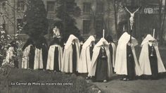 an old black and white photo of women dressed in nun costumes with crucifix behind them