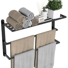 two towel racks holding towels and a potted plant