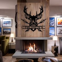 a living room filled with furniture and a fire place covered in deer head decals