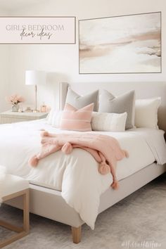 a bedroom with white bedding and pink pillows on the headboard, along with two framed pictures above it