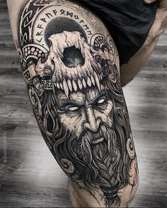 a man's leg with a tattoo on it and a skull in the middle