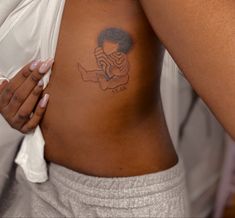 a woman with a tattoo on her stomach