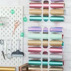 there are several rolls of tape on the wall next to scissors and other crafting supplies