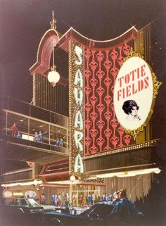 an advertisement for a hotel with people standing outside the building and looking at the sign