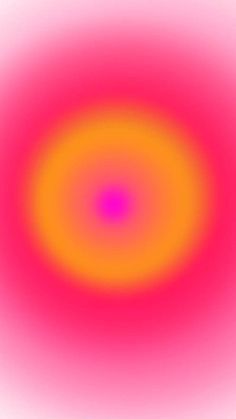 an orange and pink circular object is in the middle of a blurry image with white background