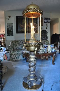 an old fashioned lamp is sitting in the middle of a living room