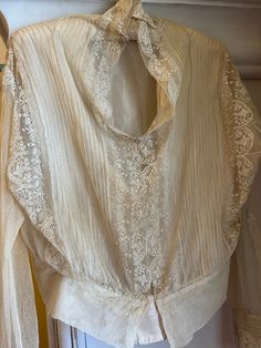 A handmade, very romantic antique Edwardian creamy double-layered blouse. Beautiful embroidery on tulle, and silk-lined bodice. Long sleeves. Pretty floral design with hand-made buttoned cuffs. Measurements:  56cm underarm to underarm.  46cm in length.  Very well preserved and in lovely wearable condition. Freshly laundered. An authentic period piece and gorgeous for use or display. Layered Blouse, Edwardian Fashion, Women's Costumes, Embroidered Blouse, Beautiful Embroidery, Vintage Tops, Floral Design, Silk, Bathing Beauties