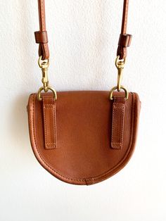 Hands down favorite purse. Vintage Coach at its finest with all the Bonnie Cashin genius brass hardware. Perfect shade of tan leather. Can be converted as a belt bag. Just have to carry you phone separately. Era: 1980'sMade in USA 5.5"(w) x 4.5"(h) x 1.5"(d) Strap drop 24" Condition: Very good. Light wear on brass closure and one small mark on top of flap (see photo). Thrifting Aesthetic, Coach Vintage Handbags, Bonnie Cashin, Favorite Purse, Leather Ideas, Vintage Coach Bags, Designer Purses, Purse Vintage, Purses Designer