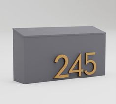 a gray box with the number twenty five in gold on it and an inscription that reads,