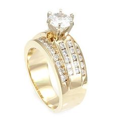 a yellow gold ring with two rows of diamonds on the band and a single diamond in the center