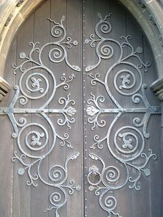 an ornate iron door is shown in this image, it appears to be made of wood and metal