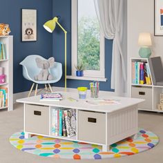 a child's room with blue walls, white bookcases and colorful rug