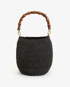 a small black basket with bamboo handles on the front and side, sitting against a white background