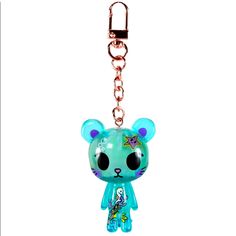 a keychain with a blue bear on it's face and a chain attached to it