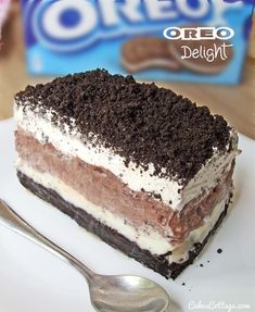 a piece of oreo ice cream cake on a white plate with a fork next to it