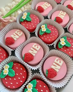 strawberry cupcakes with the word me spelled out on them