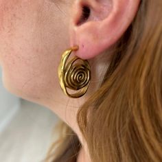 Introducing the Izzy Swirl Earring! Embrace a unique and stylish look with its elegant swirl design. Add a touch of artistry to your outfit and make a statement that will surely turn heads. Elevate your fashion game with these versatile earrings. 18K Gold Plated Over Stainless Steel Hypoallergenic Water & Tarnish Resistant All SALE items are FINAL sale Swirl-shaped Earrings With Ear Wire, Gold Swirl Earrings For Pierced Ears, Spiral Earrings With A Modern Twist, Swirl Earrings For Pierced Ears, Gold Spiral Wrap Single Earring, Elegant Spiral Brass Hoop Earrings, Modern Twist Swirl Earrings For Gifts, Spiral Gold-plated Earrings, Gold Plated Spiral Earrings