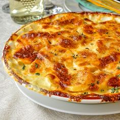 a baked dish on a table with utensils