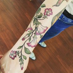 a woman's arm with flowers on it