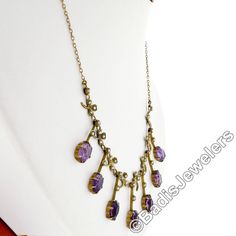 "You are looking at a rare antique collier necklace crafted in solid 14k yellow gold during the Victorian era. The center part of this beautiful necklace features elegant fringe designs alternating with clover leaf accents throughout. Each of these 7 dangle parts is set at its bottom with an old oval cut amethyst stone that shows amazing, rich purple color, and all 7 of them total approximately 14 carats in weight. The top of these fine gemstones, as well as the pretty leaf designs, are adorned Gold Art Nouveau Necklace With Gemstone, Art Nouveau Gold Necklace With Gemstone, Antique Oval Gemstone Necklace, Yellow Gold Oval Necklaces Art Nouveau Style, Victorian Purple Necklace For Anniversary, Art Nouveau Yellow Gold Oval Necklace, Antique 14k Stamped Necklaces For Formal Occasions, Art Nouveau Gemstone Necklaces For Formal Occasions, Art Nouveau Gemstone Necklace For Formal Occasions