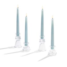 three candles are lined up next to each other with one candle in the middle and two on the side