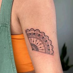 a woman's arm with a clock tattoo on the left side of her arm