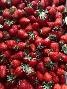 a pile of strawberries sitting on top of each other