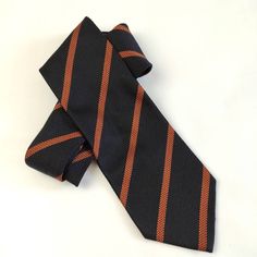 Vintage and made of 100% silk. This has a woven structure and is of good quality. Black tie with brown/bronze stripes, classic pattern Handmade in Italy Pure silk Vintage/Rare Tie length: 155 cm Width: 10 cm Material: 100% silk Brand: BRAUN Hamburg Condition: very good condition. Rare vintage find without visible defects ----------------------------------------------------------------------- Giorgio Armani Men's Tie Christian Dior Silk Ties Perry Ellis Designer Tie Robert Talbott Ties Ermenegild Classic Brown Neckwear With Ties, Classic Vertical Stripe Tie, Woven Structure, 1950s Ties Men, Luxury Striped Business Ties, Striped Suit, Luxury Striped Ties, Men Tie, Luxury Ties