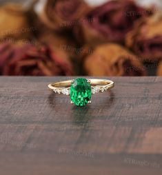 a green ring sitting on top of a wooden table