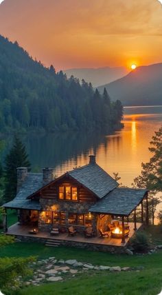 the sun is setting over a lake with a log cabin on it's side