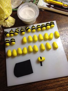 there are many yellow and black candies on the cutting board