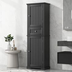 a tall gray cabinet next to a toilet in a bathroom