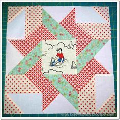 a quilted star with a person riding on it and red and white polka dots