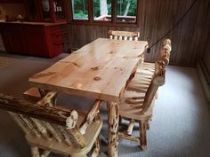 a wooden table and chairs in a room