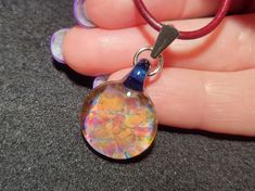 "Indulge in the beauty of handcrafted glass art with my unique tiny, dainty frit implosion glass pendants! Each trippy glass pendant is carefully crafted using top-quality Borosilicate glass and a blowtorch fueled by a mixture of oxygen and propane in my studio. I take pride in ensuring that each piece is made to perfection, using a digitally controlled environment to anneal the glass right from the flame to the kiln. The kiln is slowly ramped down overnight, guaranteeing a well-made, durable pi Jacksonville Fl, Small Hands, Propane, Glass Pendant, Glass Pendants, Leather Cord, Lobster Claw, Hand Blown, Kiln