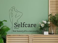 there is a wall decal that says self care not luxury, it's a necessity