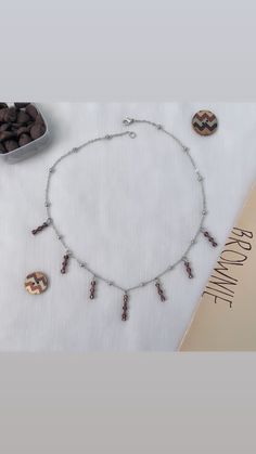 Silver necklace made with brown beads. Brown Necklace With Silver Beads For Gift, Bohemian Brown Necklace With Silver Beads, Nature-inspired Brown Beaded Necklace Gift, Gift Silver Beads Multi-strand Necklace, Adjustable Multi-strand Silver Charm Necklaces, Brown Necklace, Zipped Bag, Butterfly Necklace, Silver Chain Necklace