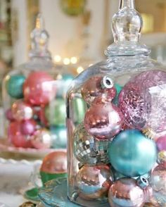 a glass clochet filled with ornaments on top of a table