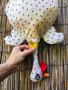 someone is holding a stuffed animal in front of a ratty place mat that has been placed on top of it