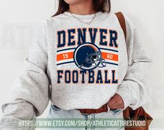 Denver Football Vintage Style Sweatshirt T-Shirt,Retro Denver Football Crewneck Shirt,Denver Footbal Fans Gift Sweater,Sunday Football FLC10 **Please note this product is offered in multiple styles (Sweatshirt/T-shirt). Please make sure to choose the correct style you wish to purchase. ⭐𝐐𝐔𝐀𝐋𝐈𝐓𝐘: At Athletic Attire, we are committed to using top-notch materials for our products. Our designs feature high-quality ink that results in bright, durable prints. Once you try our sweatshirts and te Broncos Sweatshirt, Athletic Attire, Sunday Football, Football Sunday, Football Vintage, Oversized T Shirt Dress, Football Sweatshirt, Style Sweatshirt, Sweater Gift