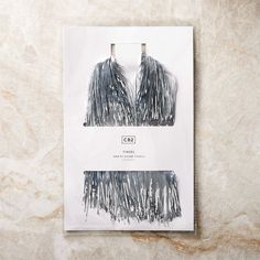 a magazine with two pieces of fringe on it