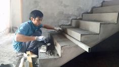 a man in blue shirt and white gloves working on stairs