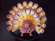 a turkey made out of crackers on a plate