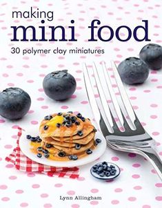 the cover of making mini food, with blueberries and pancakes on a white plate